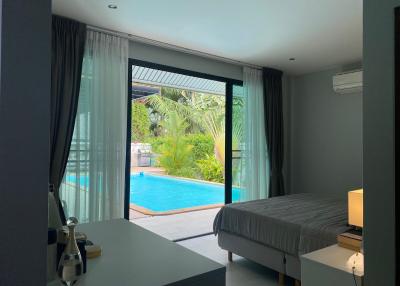 Modern bedroom with direct access to swimming pool