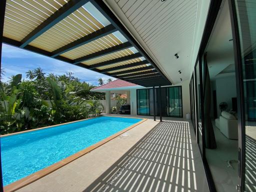 Modern home exterior with swimming pool and patio area