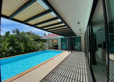 Modern home exterior with swimming pool and patio area