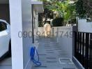 Paved pathway leading to a modern home entrance with parked car