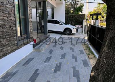 Modern house exterior with paved driveway and parked car
