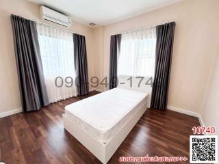 Spacious bedroom with air conditioning and hardwood flooring