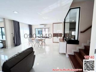 Spacious and modern living room with dining area and staircase