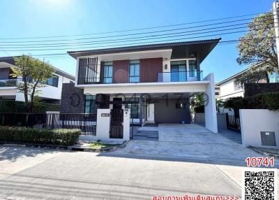 Modern two-story house with spacious garage and balcony in a residential area