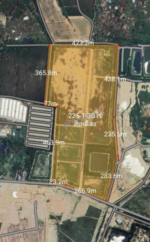 Aerial view of a large land plot with demarcated boundaries and nearby geographical features