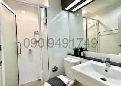 Modern bathroom with glass shower enclosure and white fixtures