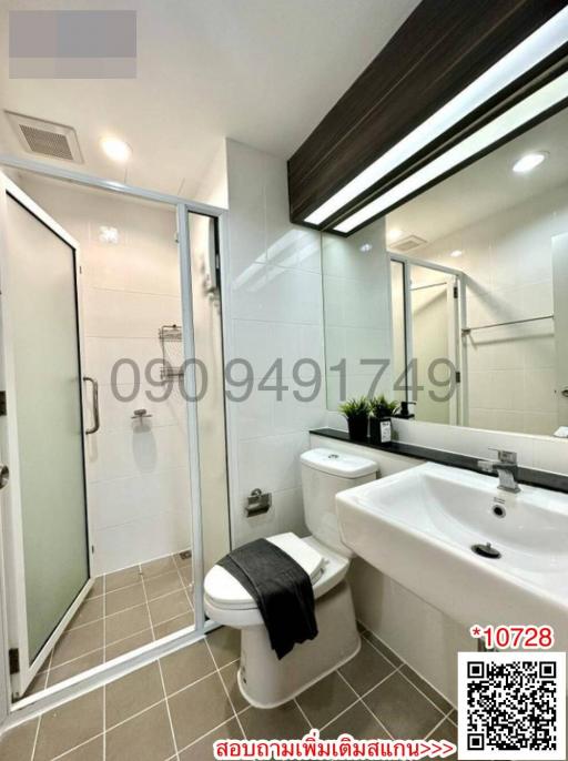 Modern bathroom with glass shower enclosure and white fixtures