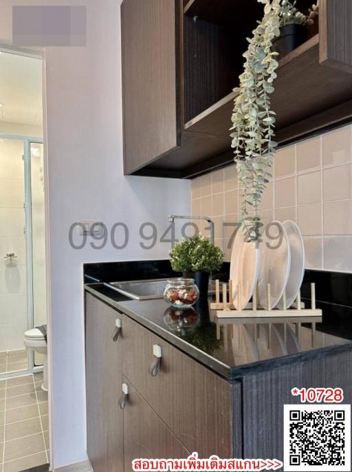 Modern compact kitchen with integrated appliances and access to bathroom