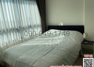 Cozy bedroom with natural light filtering through curtains