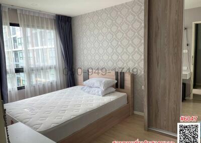 Modern bedroom with large window and patterned wallpaper