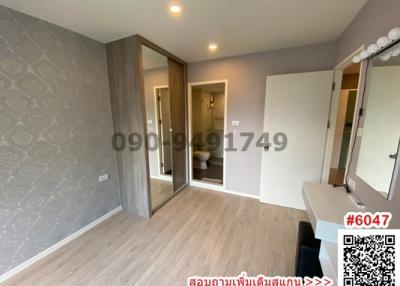 Spacious bedroom with ensuite bathroom and wooden flooring
