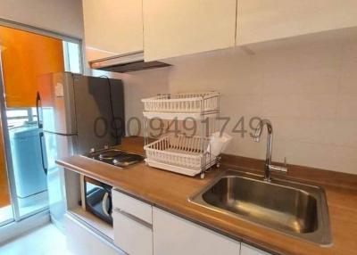 Compact modern kitchen with stainless steel sink