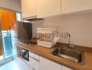 Compact modern kitchen with stainless steel sink