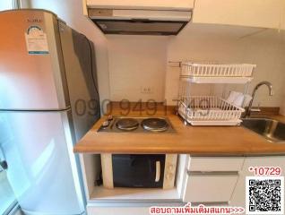 Compact kitchen with modern appliances and wooden countertops