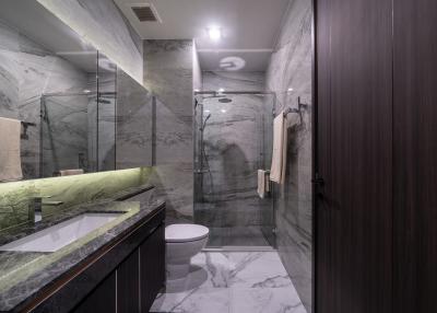 Modern bathroom with marble tiles and glass shower