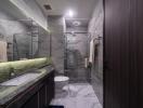 Modern bathroom with marble tiles and glass shower