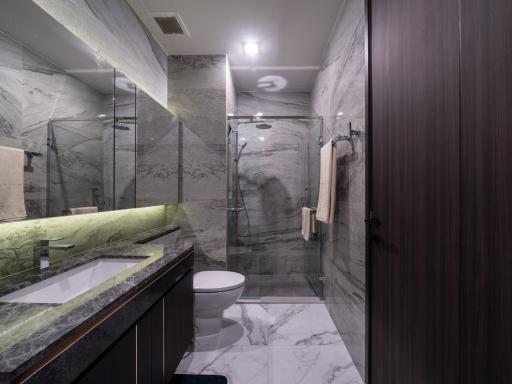 Modern bathroom with marble tiles and glass shower