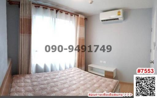 Cozy bedroom with large window and modern air conditioning unit