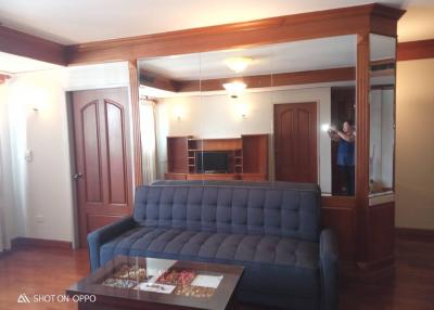 Elegant living room with wooden finishes and a comfortable blue sofa