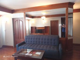 Elegant living room with wooden finishes and a comfortable blue sofa