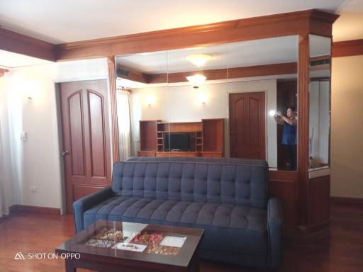 Elegant living room with wooden finishes and a comfortable blue sofa