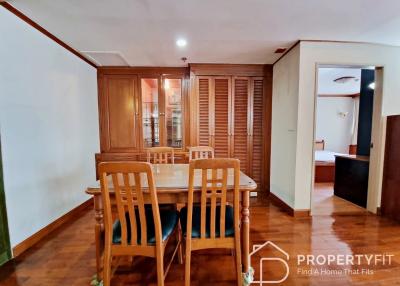 Cozy dining room with wooden furniture and glass door cabinets