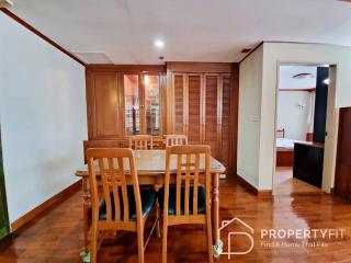 Cozy dining room with wooden furniture and glass door cabinets