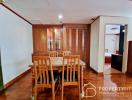 Cozy dining room with wooden furniture and glass door cabinets