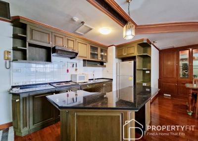 Spacious kitchen with modern appliances and wooden cabinets