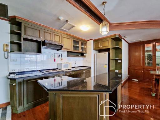 Spacious kitchen with modern appliances and wooden cabinets