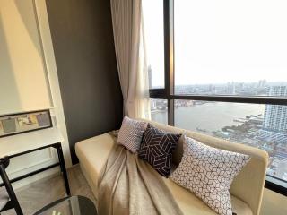 Modern living room with a large window overlooking the city