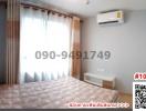 Cozy bedroom interior with large window and air conditioning unit