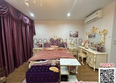 Elegant bedroom with luxurious furniture and bold purple bedding