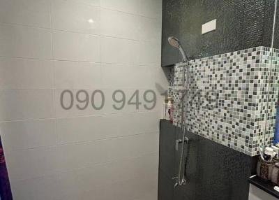 Modern bathroom with neutral tile design and shower area