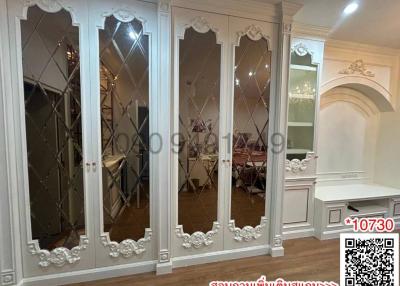 Elegant bedroom with mirrored wardrobe doors and white trim