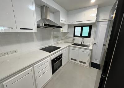 Modern white kitchen with stainless steel appliances