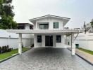 Contemporary two-story home with spacious driveway and manicured lawn