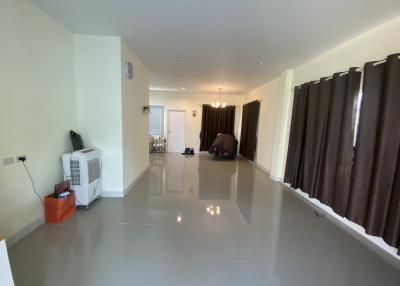 Spacious living room with tiled flooring and natural light