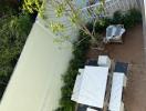 Aerial view of an outdoor patio area with garden and seating