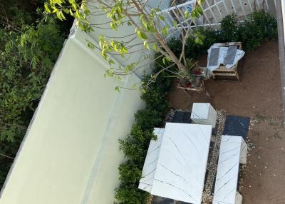Aerial view of an outdoor patio area with garden and seating