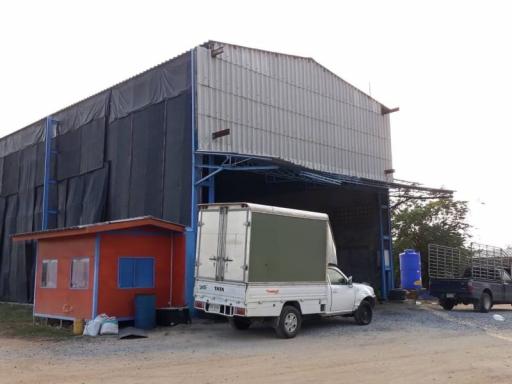 Industrial warehouse with exterior office space and loading truck