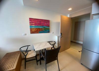 Compact dining area with modern furniture and vibrant wall art