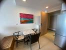 Compact dining area with modern furniture and vibrant wall art