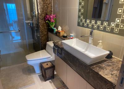 Modern bathroom with beige tiles and elegant fixtures