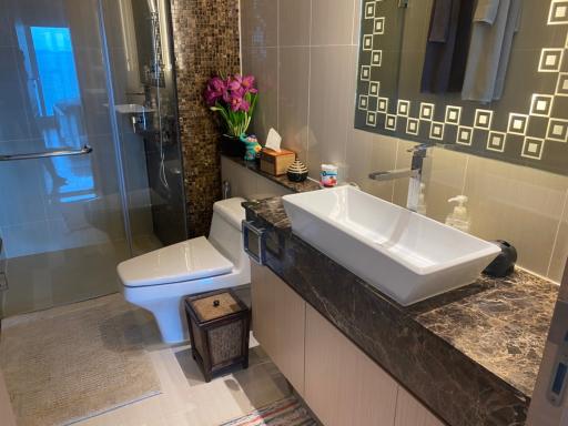 Modern bathroom with beige tiles and elegant fixtures