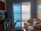 Cozy living room with sofa and sea view through large windows