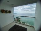 Spacious room with large window offering panoramic ocean views