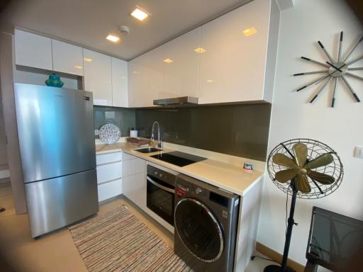 Modern kitchen with stainless steel appliances and ample lighting