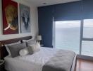 Modern bedroom with ocean view and artistic animal portraits