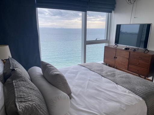 Ocean view bedroom with large windows